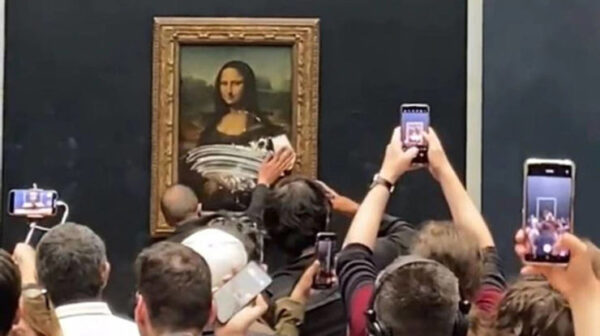 Disguised Man Held Back After Vandalizing Mona Lisa with a Slice of Cake